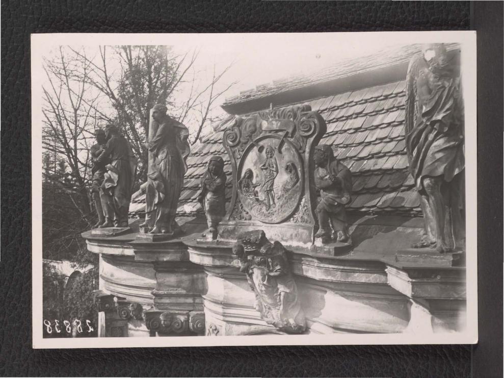 fotografia czarno-biała przedstawiająca gzyms miejscowego pałacu zdobionego figurami i reliefem z motywem śmierci bądź też zmartwychwstania nawiązującego do tzw. wizji kości Ezechiela, skan 1