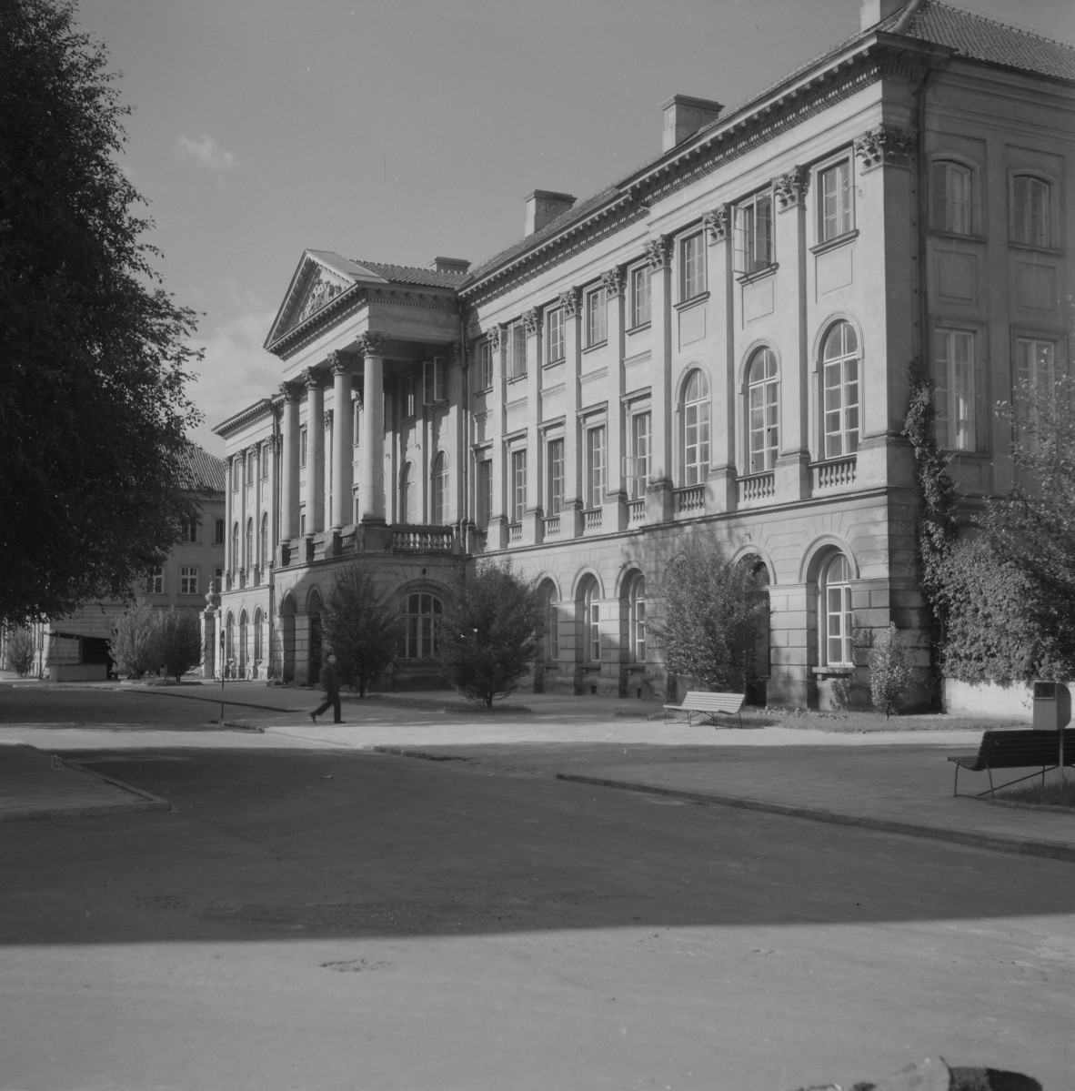 Pałac Kazimierzowskich. Korpus główny dwukondygnacyjny osadzony na wyraźnie wydzielonym, wysokim przyziemiu. Dolna kondygnacja ma cięższy, bardziej masywny charakter, z rytmem arkadowych otworów i boniowaniem, co wzmacnia wrażenie solidnej bazy. Fasada jest ściśle symetryczna i podporządkowana osi głównej, typowej dla architektury reprezentacyjnej. Najsilniejszym akcentem jest portyk kolumnowy od frontu, zwieńczony trójkątnym frontonem. To element jednoznacznie odwołujący się do repertuaru antycznego i klasycystycznego. , skan 1
